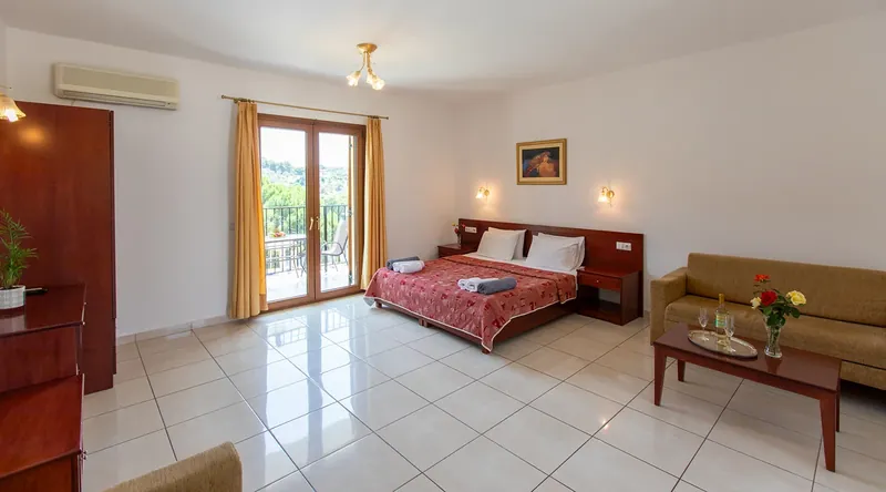 An apartment with its bed, sofa and balcony doors