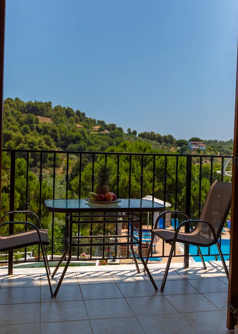 A balcony looking out to the wooded hills