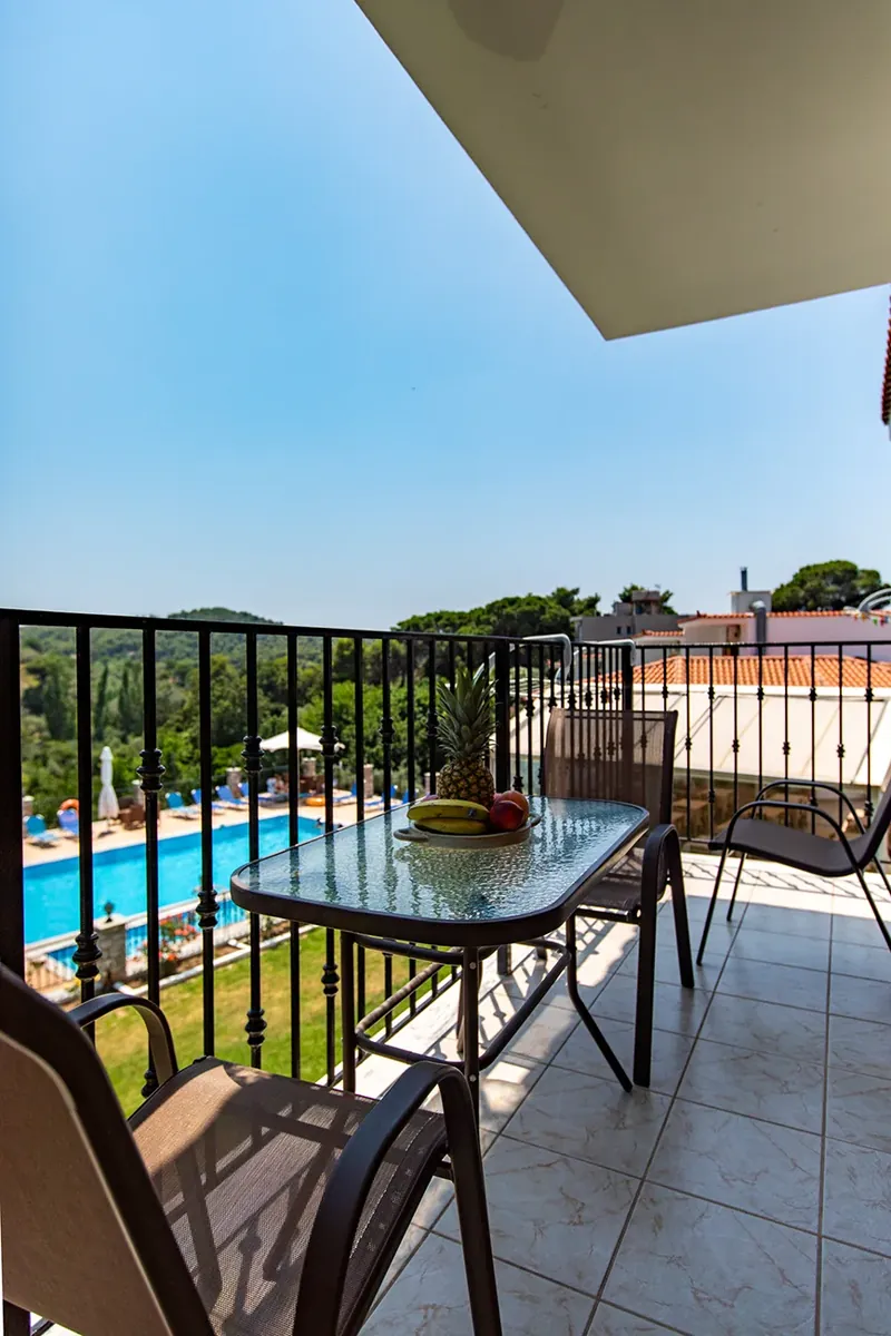 A balcony table looking down on the pool