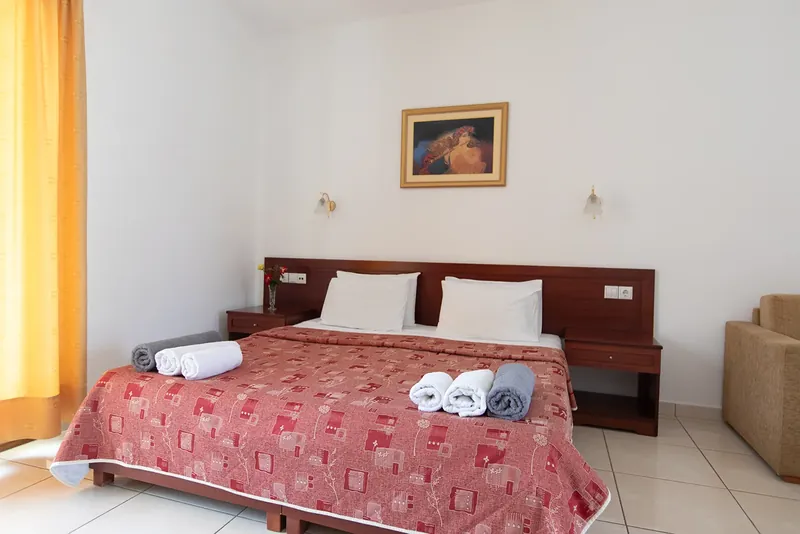 A double bed with folded towels