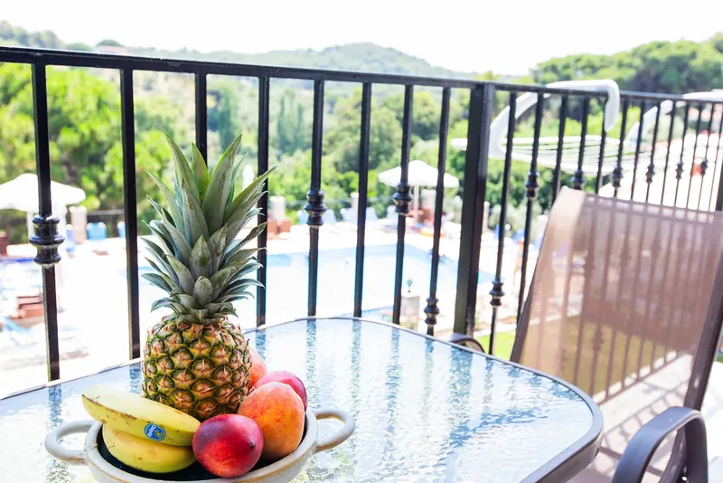 A bowl of fruit on the balcony table