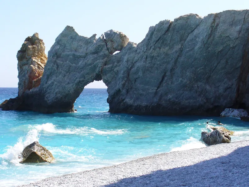 The rock arch and white pebbles of Lalaria beach