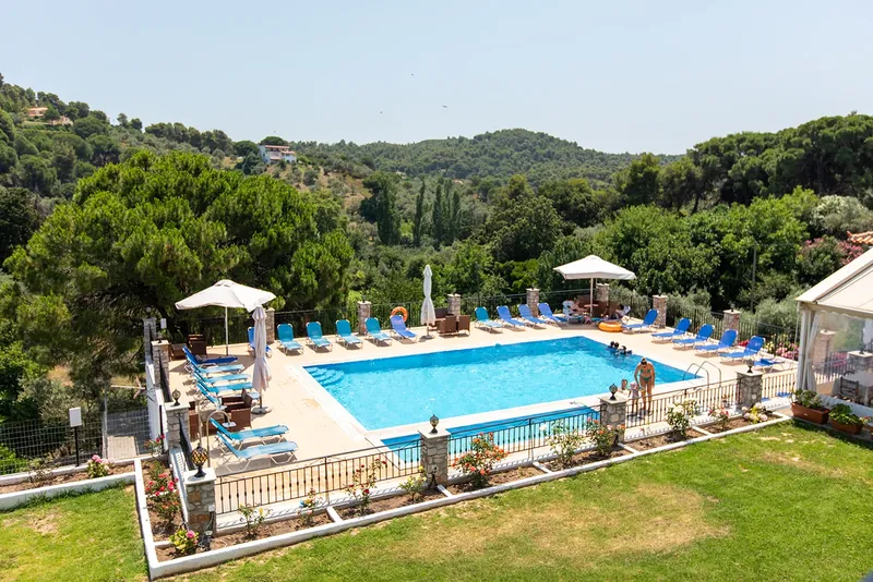 The pool and the green valley from an apartment balcony